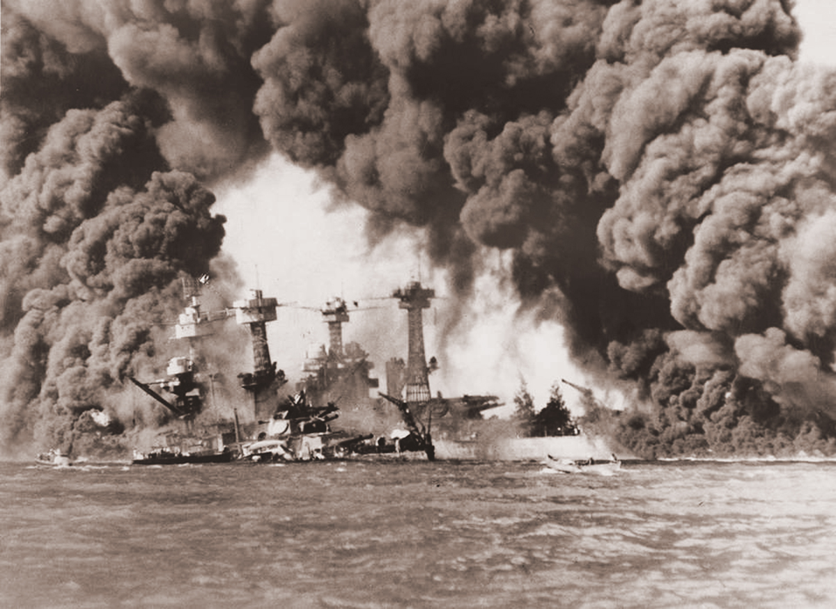 Historical black and white photograph depicting the USS West Virginia engulfed in smoke and flames during the attack on Pearl Harbor, as documented by the Naval History and Heritage Command, photo number 97398-3.