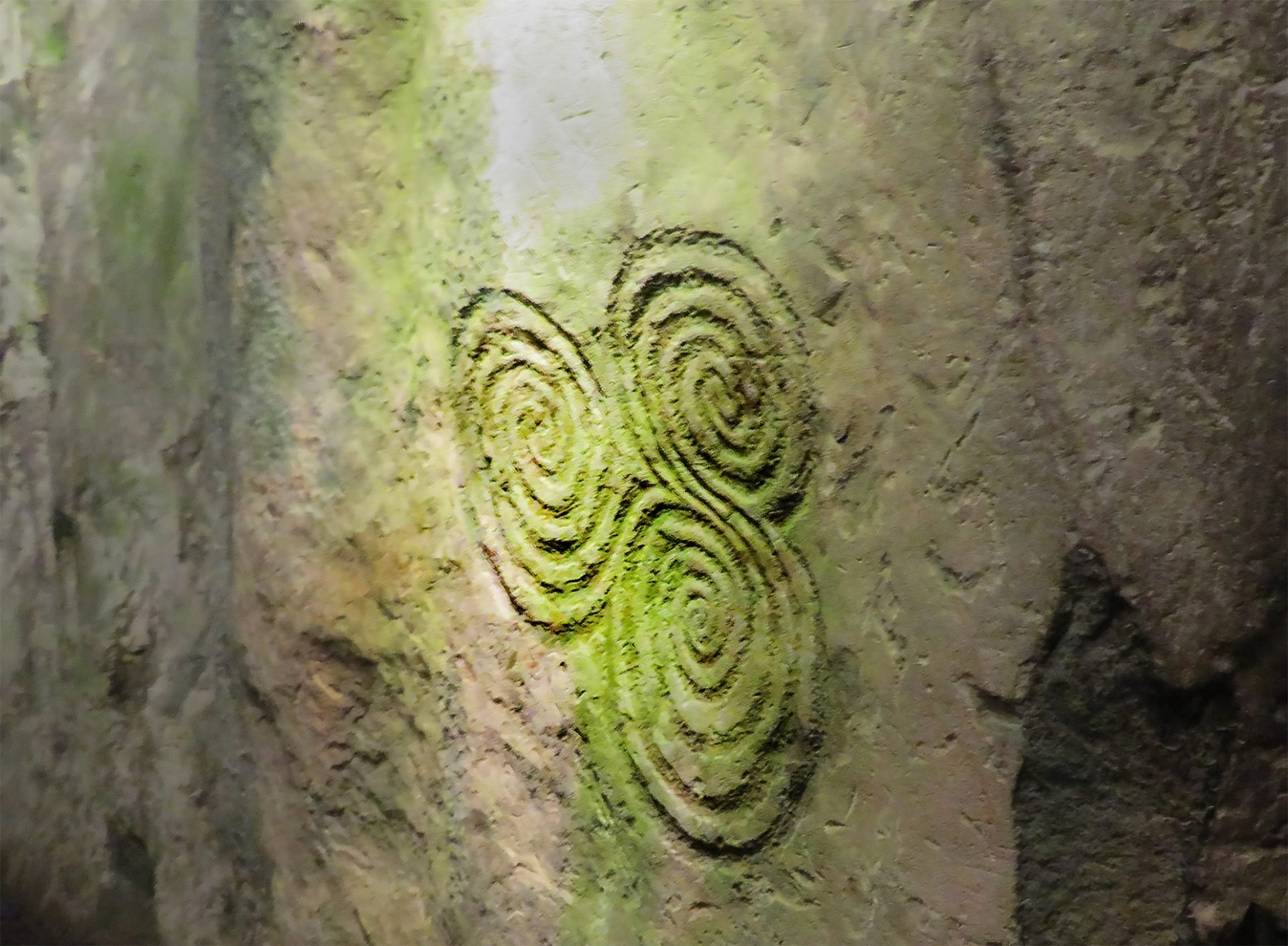 The triskele, a triple spiral motif carved into the stone wall of the inner chamber of the Newgrange passage tomb in Ireland, symbolizing a concept associated with Druidic beliefs.