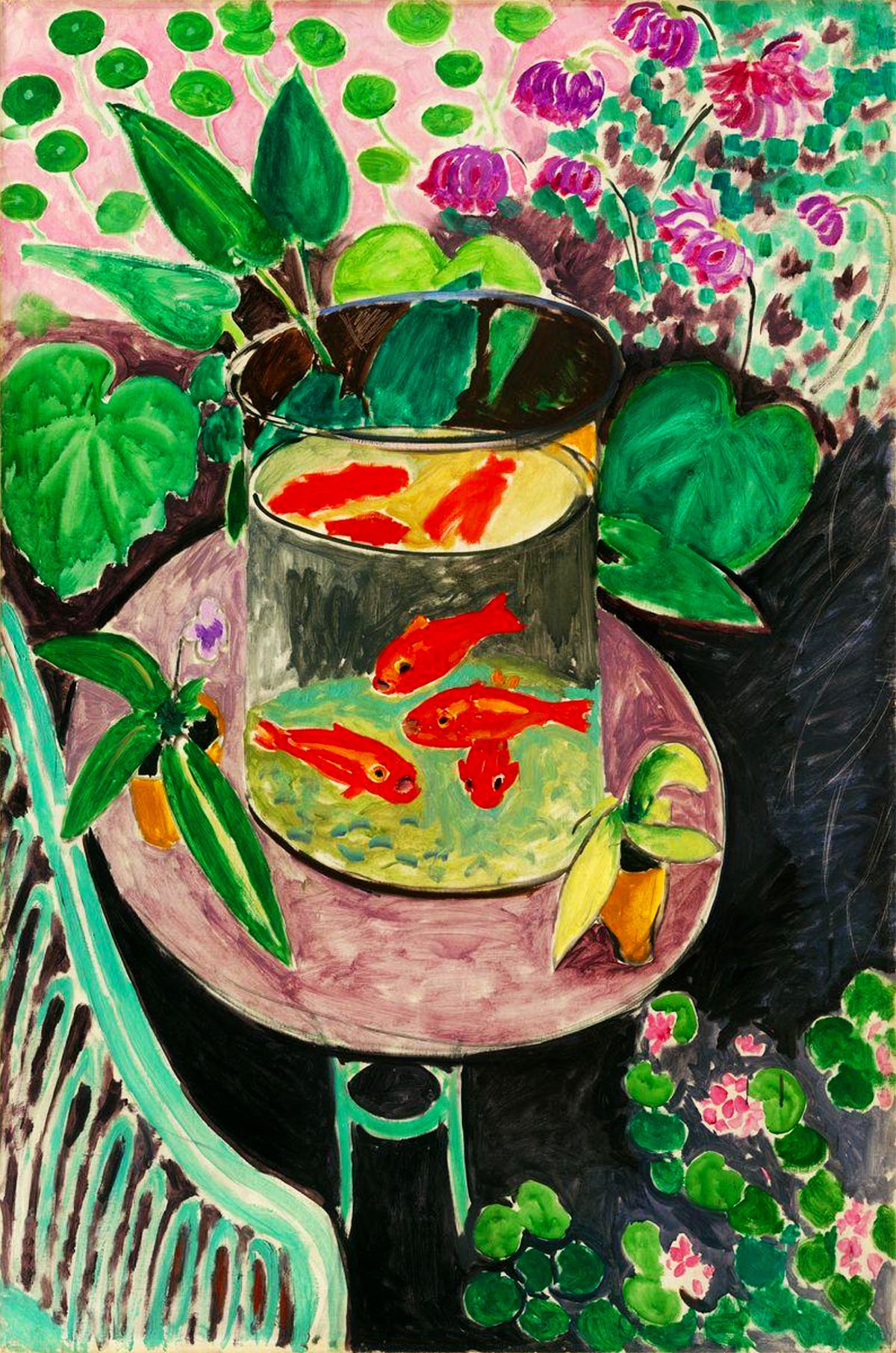 This image displays Henri Matisse's painting "Goldfish" from 1912. It portrays a vibrant scene focused on a glass bowl on a table, containing brightly colored orange goldfish swimming against a contrasting pale yellow background. Surrounding the bowl are lush green plants with broad leaves, and in the background, there is a decorative floral curtain with pink and purple accents. The entire composition is set against a backdrop of a dark floor, with the bold use of complementary colors creating a lively and dynamic still life.