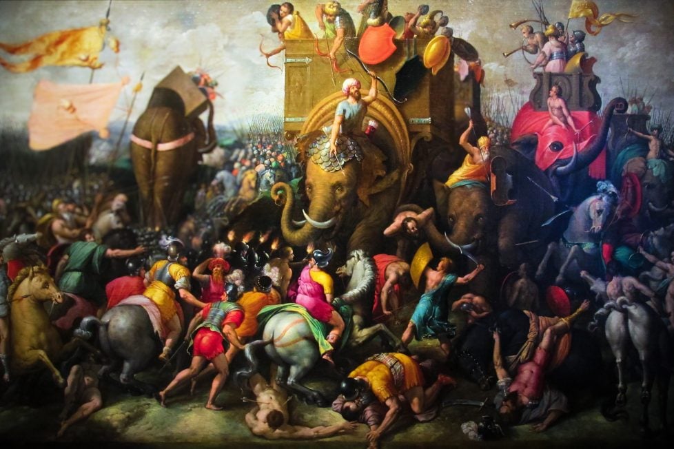 A dramatic painting of the Battle of Zama portraying the chaotic intensity of the Punic Wars with Carthaginian war elephants at the center, surrounded by battling soldiers in vibrant attire.